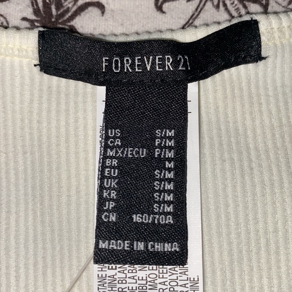 Selling top from forever 21 the size is S/M the color is cream white - Picture 3 of 4